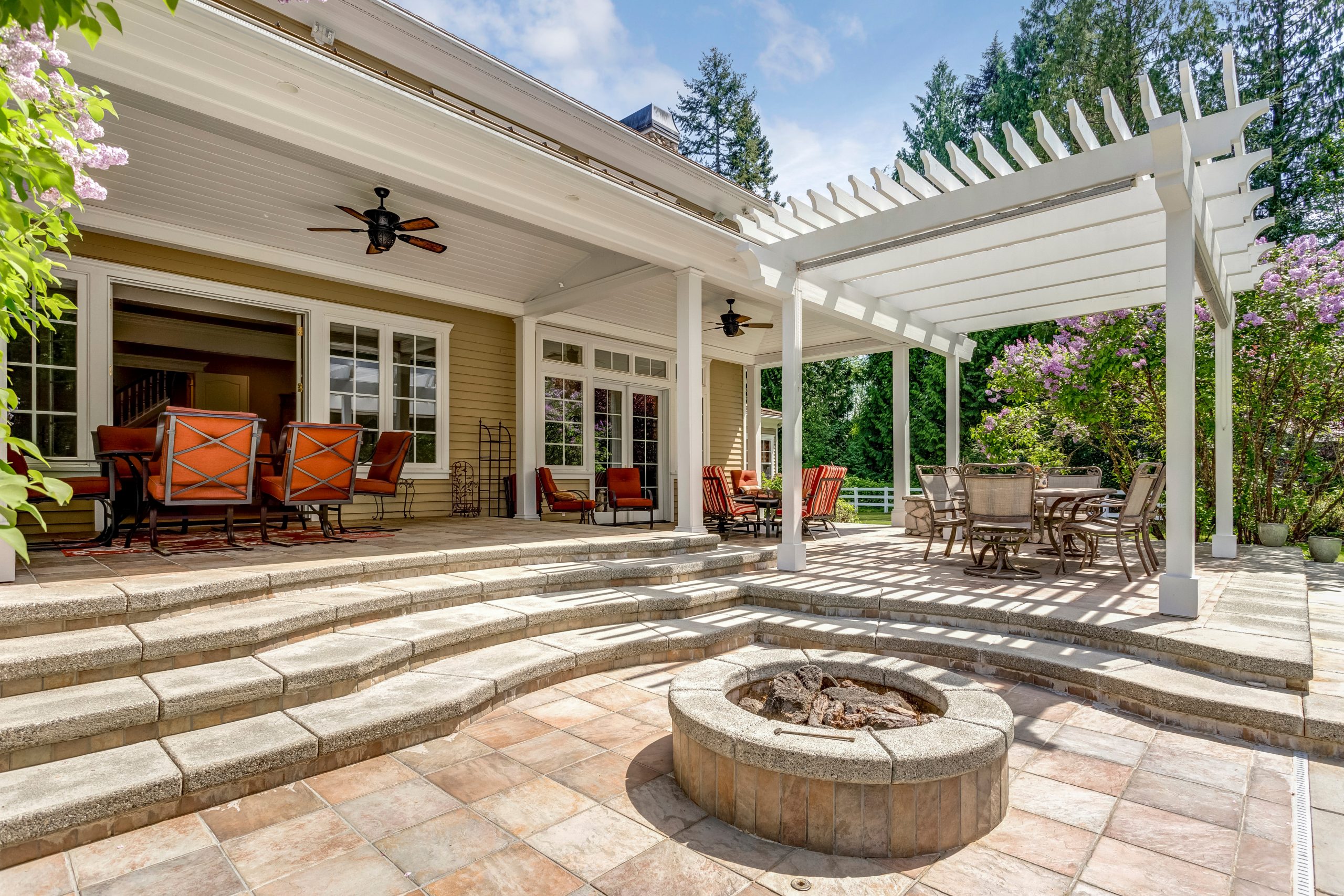 Elegant Patio with Pergola, Stone Steps, and Fire Pit
